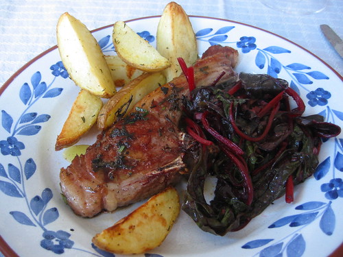 Grilled lamb chop with oven baked potatoes and stir fried beet greens