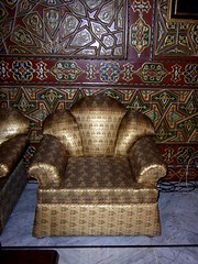Chair upholstered in gold damask brocade